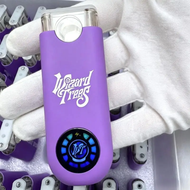 Hand inspection of a Wizard Trees empty vape led screen hardware to verify build quality and pre-heat display functionality.
