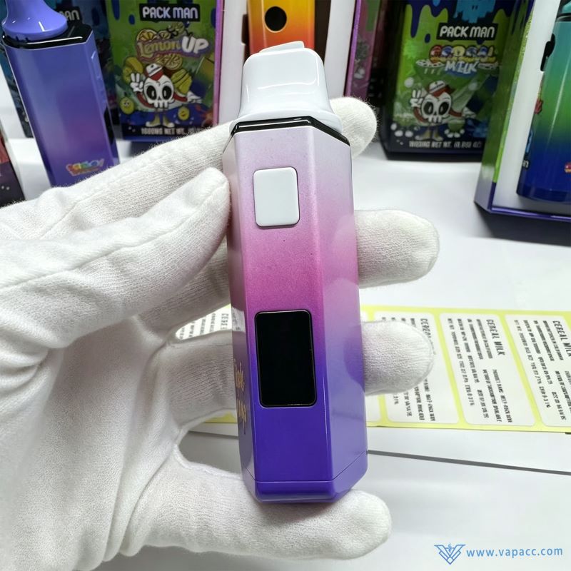 Close-up handheld view of Empty Melt x PackMan 2ml vape hardware wholesale showing side button and digital screen.