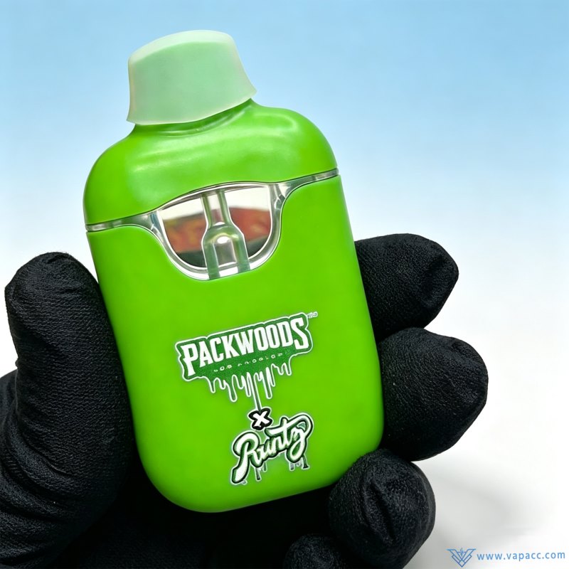 empty packwoods x runty v2 green disposable vape device in hand