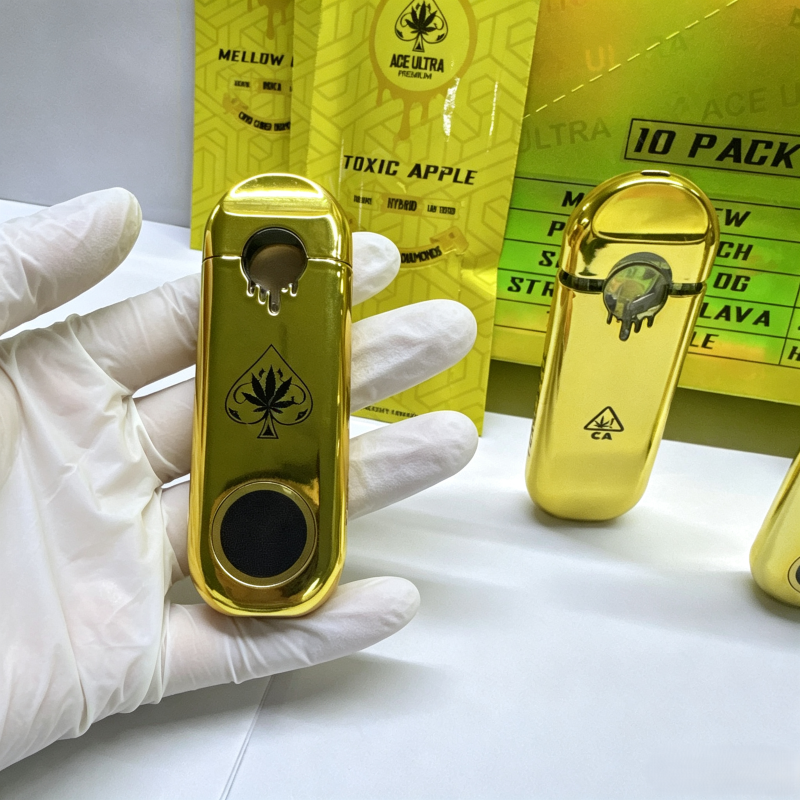 Gloved hand holding an Empty Ace Ultra V6 1g & 2g premium gold rechargeable device.