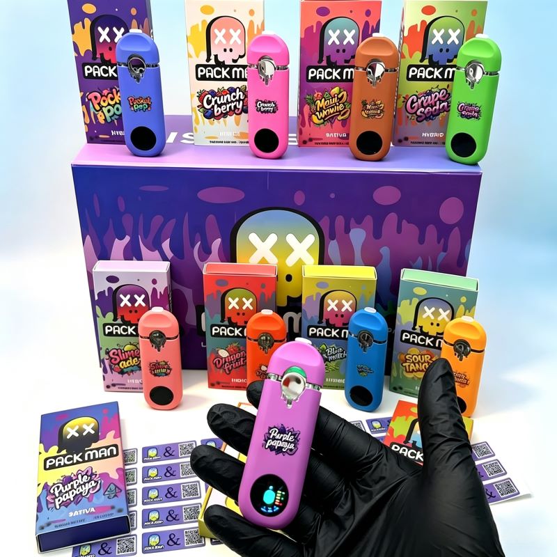 Handholding a purple Pack Man 1g empty disposable vape device showcasing the active LED screen display.