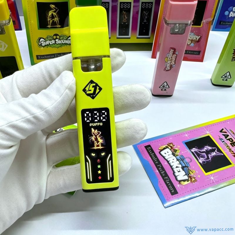 Handheld close-up of yellow Sluggers Hit 1g empty vape pen showcasing activated puff screen and oil window.