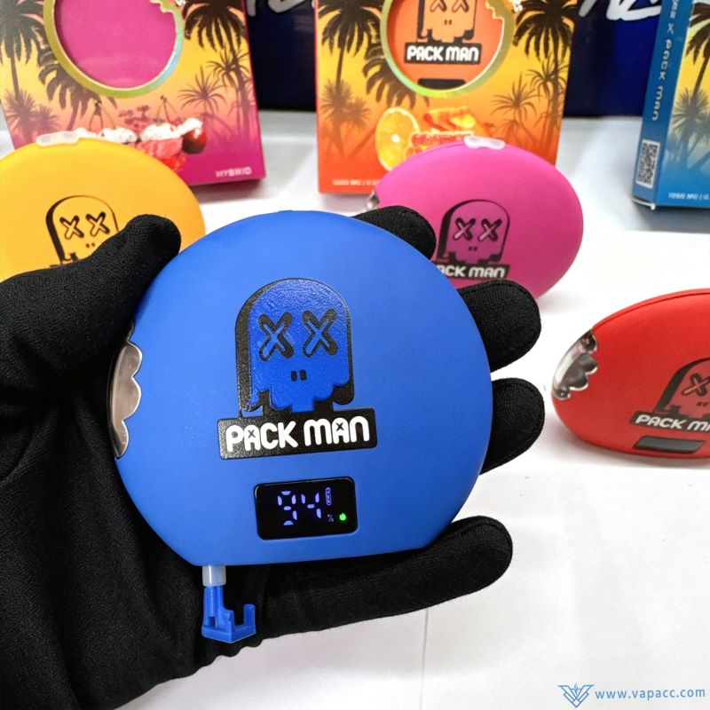 Hand holding blue Packman Cookies 1g empty vape with active digital LED battery screen